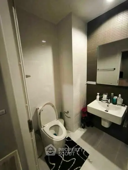 Modern bathroom with sleek fixtures and stylish decor in a contemporary apartment.