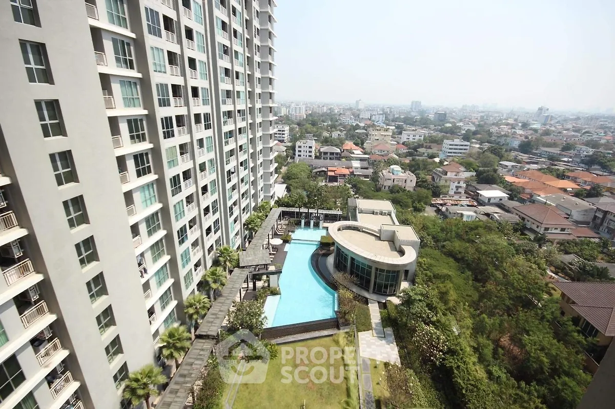 Stunning high-rise building with pool and lush garden offering panoramic city views.