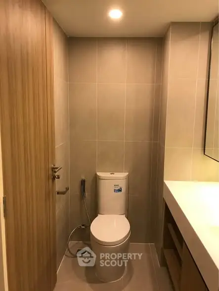 Modern bathroom with sleek design and contemporary fixtures in a stylish real estate property.