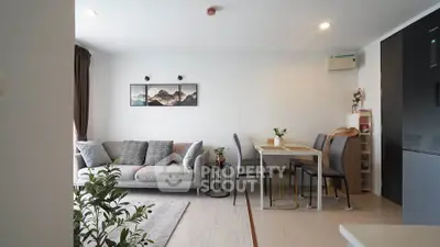 Modern living room with cozy sofa and dining area in open layout apartment