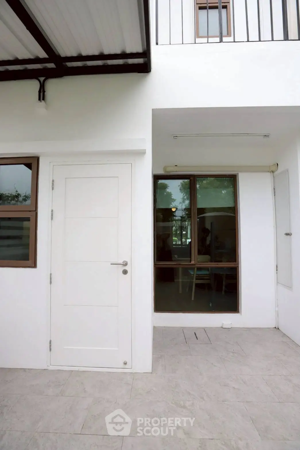 Modern white exterior with large windows and sleek door design