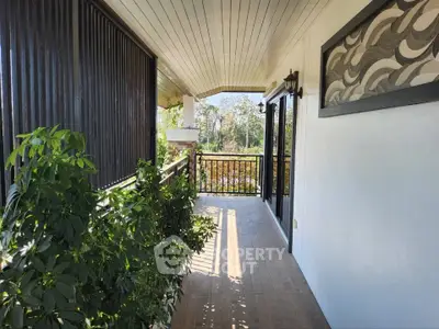 Charming balcony with lush greenery and scenic view, perfect for relaxation and enjoying nature.