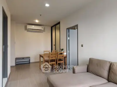 Modern living room with dining area and air conditioning in a cozy apartment.
