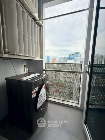 Modern apartment balcony with washing machine and city view, perfect for urban living.