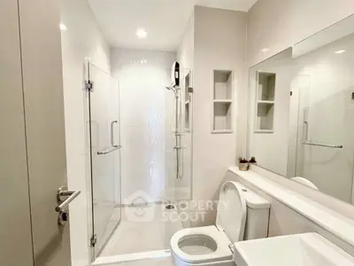 Modern bathroom with glass shower and sleek fixtures