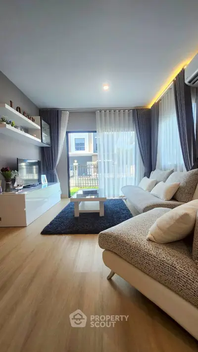 Modern living room with stylish decor and large windows for natural light