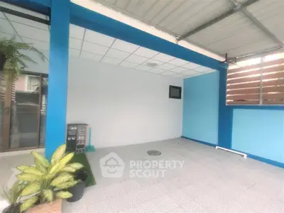 Spacious covered outdoor area with modern design and vibrant blue accents