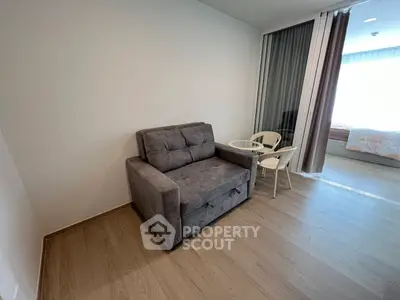 Cozy living area with modern sofa and dining set in a stylish apartment