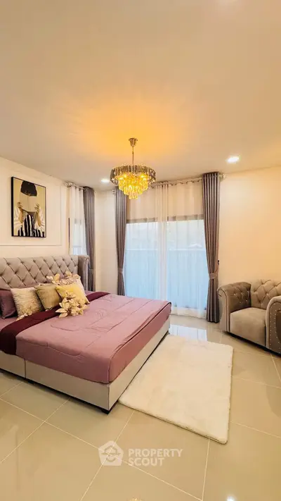 Luxurious bedroom with elegant chandelier and plush furnishings in modern home