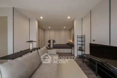 Modern living room with sleek design and neutral tones, featuring a comfortable sofa and stylish decor.