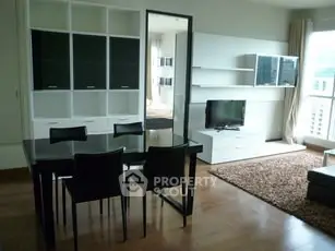 Modern living room with sleek furniture and large windows in a stylish apartment.