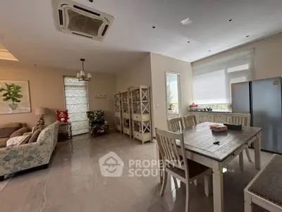 Spacious open-plan living and dining area with modern decor and natural light.