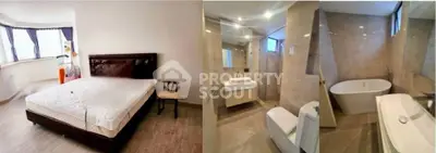 Spacious bedroom with large windows and modern bathroom featuring a bathtub, ideal for luxury living.