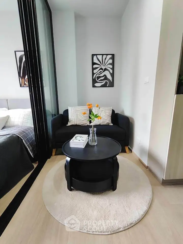 Cozy living room with modern decor and stylish black sofa