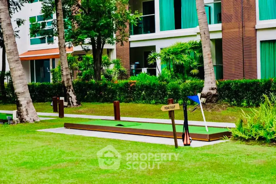 Luxurious garden view with mini golf course in modern residential complex.