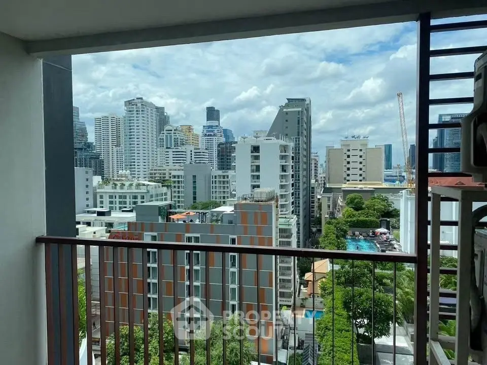 Stunning cityscape view from a modern balcony in a high-rise building.