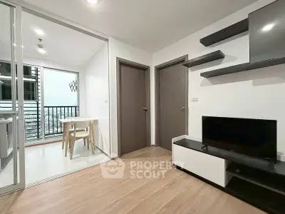 Modern living room with sleek furniture and balcony view in a stylish apartment.