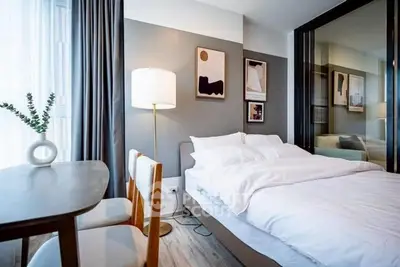 Modern bedroom with stylish decor and natural light