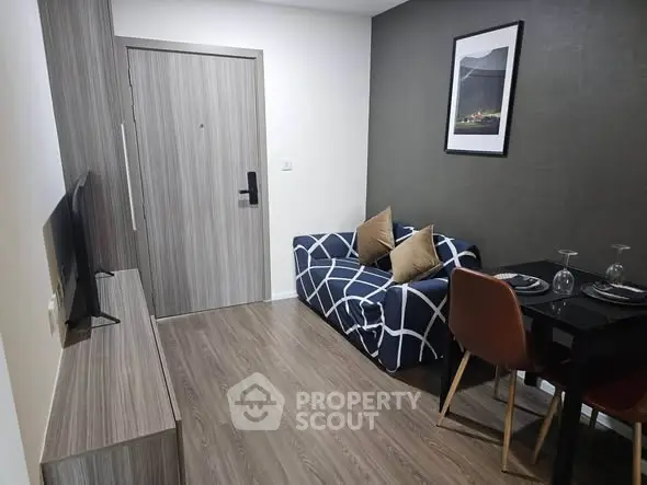 Modern living room with stylish decor and compact dining area, perfect for urban living.