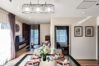 Elegant open-plan living and dining area with modern decor and natural light.