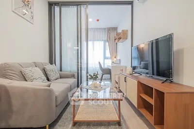Modern living room with cozy sofa and large TV in stylish apartment