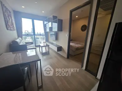 Modern apartment interior with city view, featuring a cozy living room and adjacent bedroom.