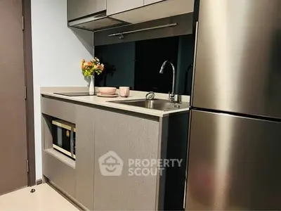 Modern compact kitchen with sleek cabinetry and stainless steel appliances