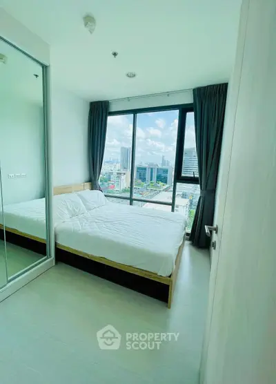 Modern bedroom with large window offering stunning city view