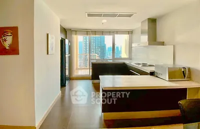 Spacious modern kitchen with open layout and city view, featuring sleek appliances and ample counter space.