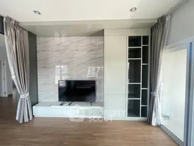 Modern living room with sleek TV unit and elegant curtains