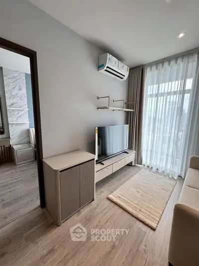 Modern living room with sleek TV setup and large window view