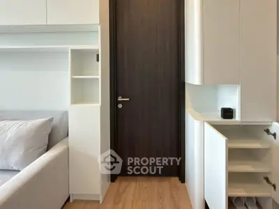 Modern interior with sleek cabinetry and cozy sofa in a stylish living space.