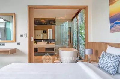 Luxurious bedroom with ensuite bathroom featuring a freestanding bathtub and modern decor.