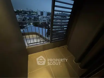 Cozy balcony with city view at dusk, perfect for relaxation and enjoying the skyline.