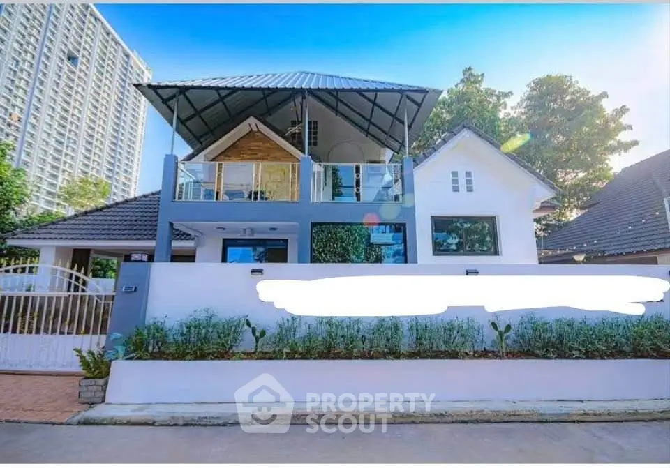 Charming modern house with spacious balcony and lush greenery, perfect for serene living.