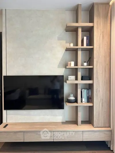 Modern living room with stylish wooden TV unit and shelving, perfect for contemporary homes.