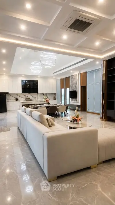 Luxurious open-plan living room with modern decor and elegant lighting in a spacious apartment.