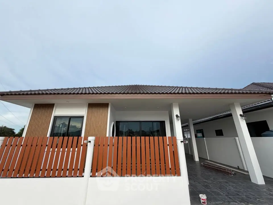 Modern single-story house with stylish wooden fence and tiled roof