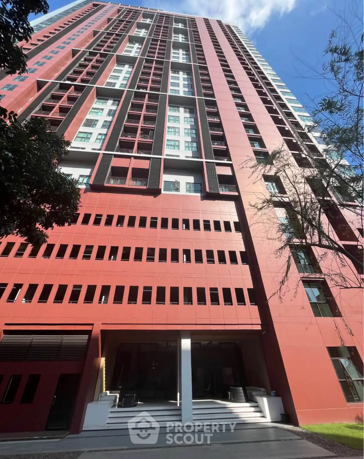 Stunning red high-rise building with modern architecture and sleek design.