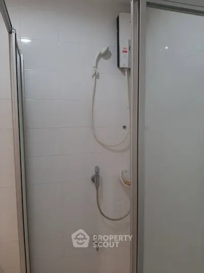 Modern bathroom shower area with sleek design and white tiles