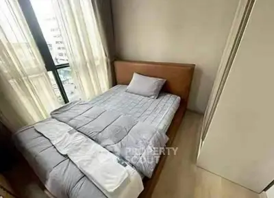 Cozy bedroom with natural light and modern decor in a stylish apartment.