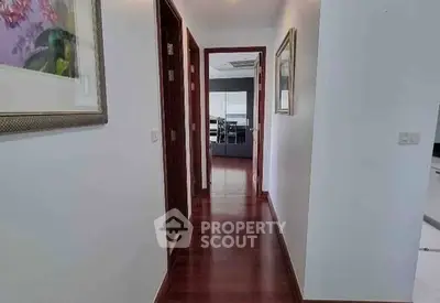 Modern hallway with wooden flooring leading to a stylish living room.