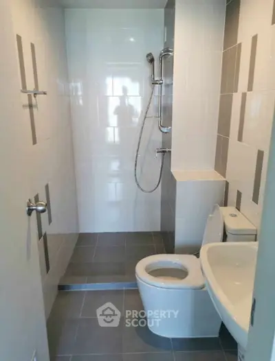 Modern bathroom with sleek design and walk-in shower in a contemporary apartment.