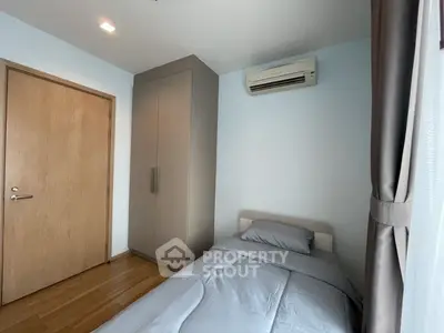 Cozy bedroom with air conditioning and modern wardrobe in a stylish apartment.