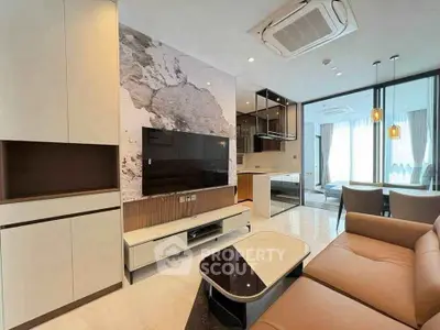 Modern living room with stylish decor and open kitchen layout in luxury apartment.