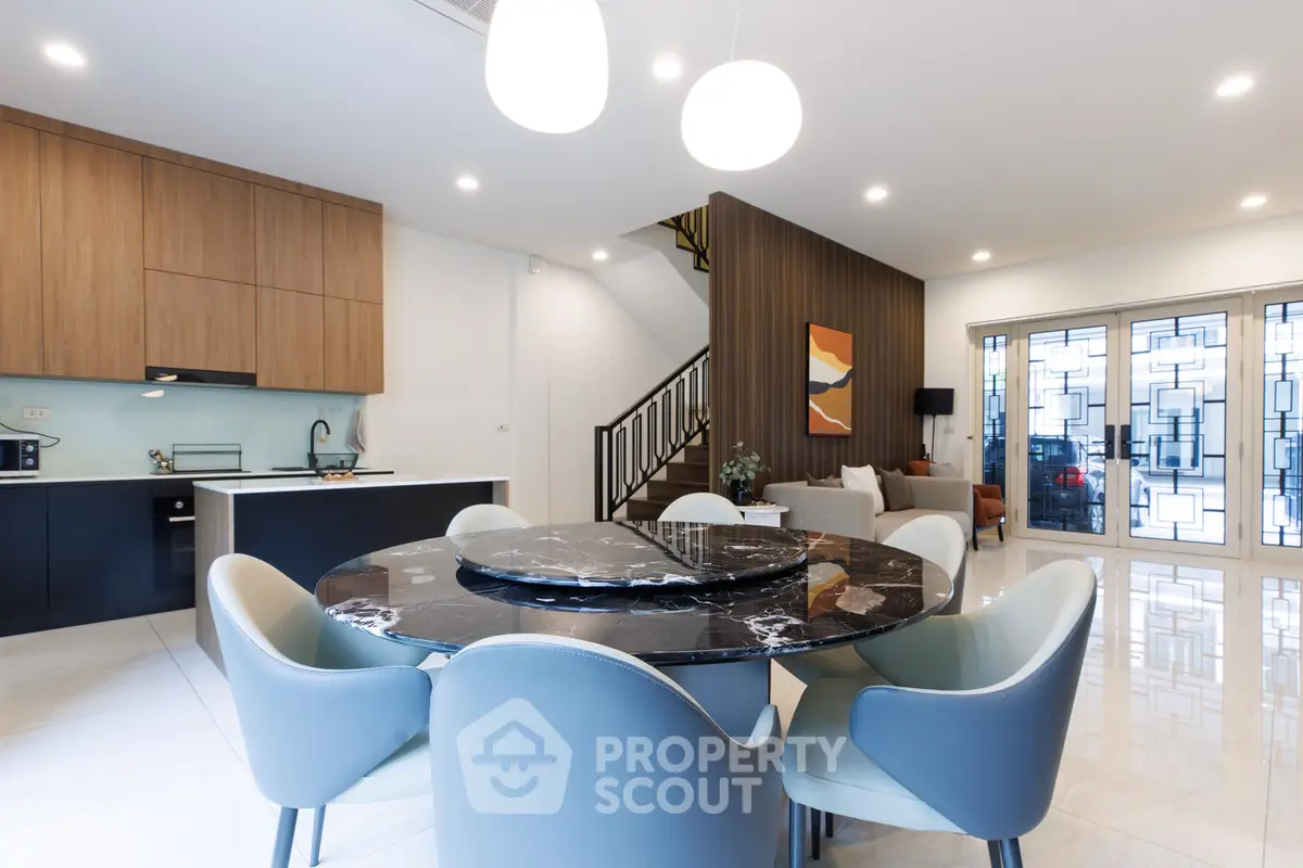 Modern open-plan living and dining area with stylish furniture and elegant lighting.