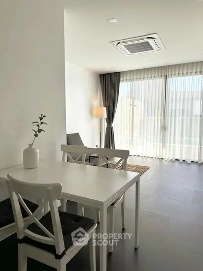 Bright modern living room with sleek furniture and large windows for natural light.