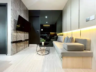 Modern living room with sleek design, wall-mounted TV, and stylish furniture