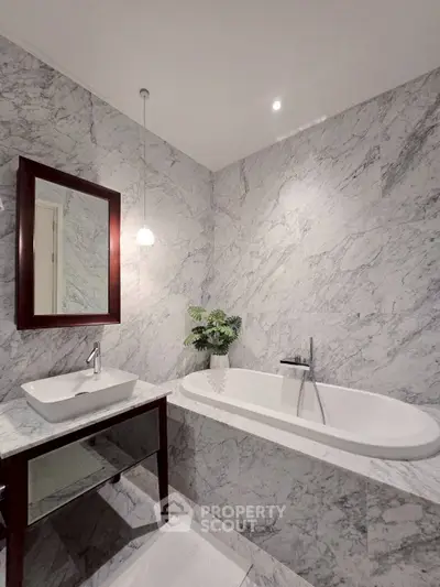 Luxurious marble bathroom with elegant bathtub and modern sink