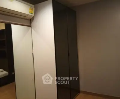 Modern bedroom with sleek wardrobe and air conditioning unit